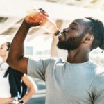 Fitness african athlete drinking energy drink outdoor
