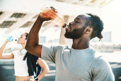 Fitness african athlete drinking energy drink outdoor