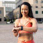 Portrait of brazilian female with wearable technology. Middle age woman checking activity